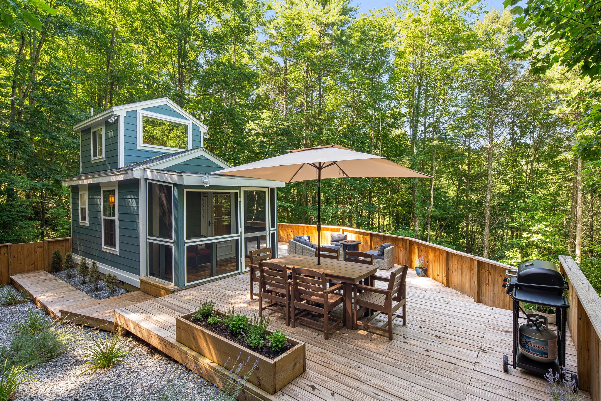 The Tiny Buffalo exterior with deck and forest views